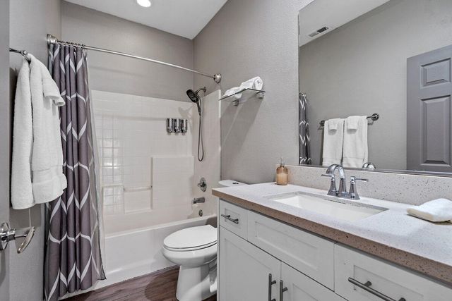 a bedroom with two beds and a chandelier