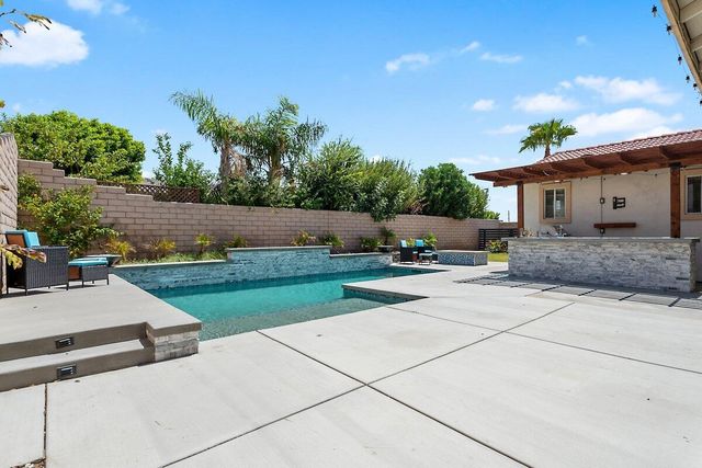 a view of a backyard with sitting area