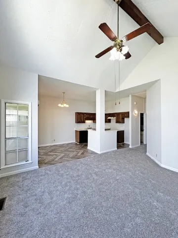 a view of a kitchen with a sink and a ceiling fan