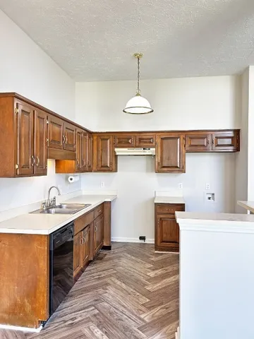 a kitchen with a sink stainless steel appliances and cabinets
