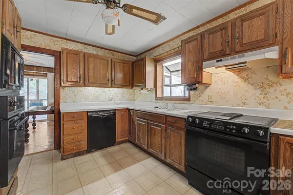a kitchen with stainless steel appliances granite countertop a stove sink and cabinets
