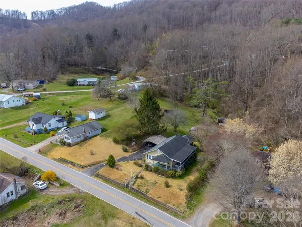 an aerial view of a house with a yard