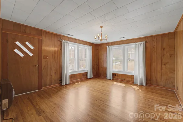 a view of an empty room with wooden floor