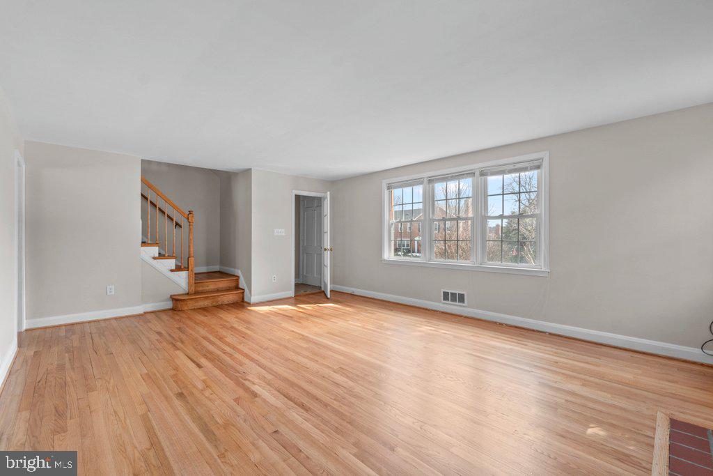 1522 Doxbury Road Baltimore, MD 21286 - Photo 4 of 28 a view of an empty room with wooden floor and a window
