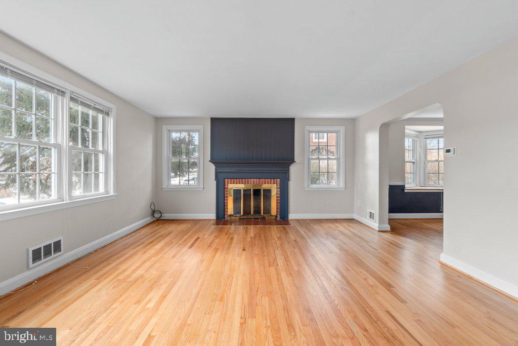 1522 Doxbury Road Baltimore, MD 21286 - Photo 6 of 28 a view of an empty room with wooden floor and a window