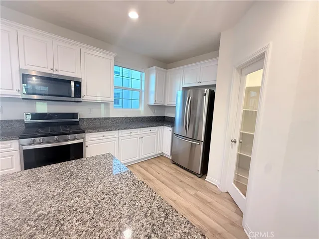 a bathroom with a shower sink vanity mirror and toilet