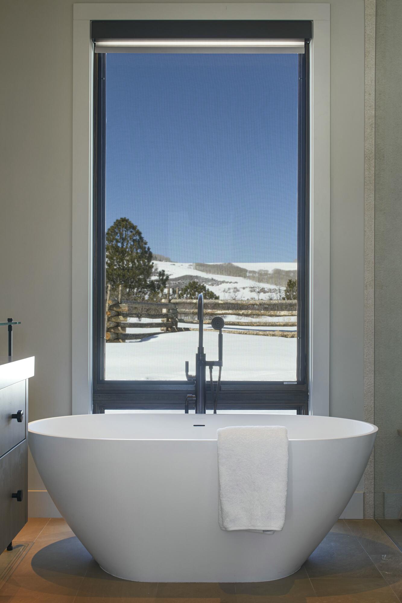 1050 / 973 Posey Road Placerville, CO 81430 - Photo 12 of 18 a white tub sitting next to a window