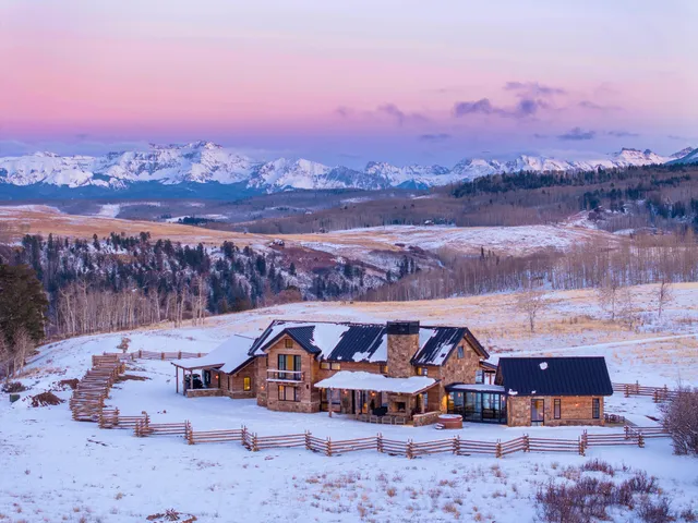 an aerial view of a house with a city view
