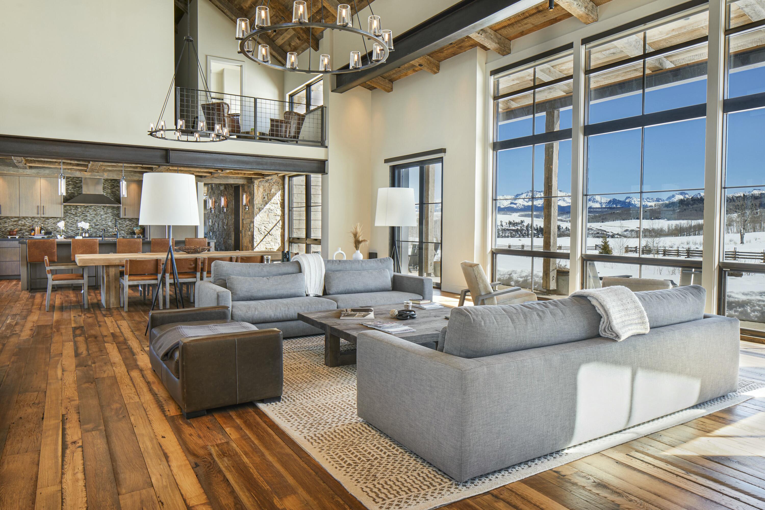 1050 / 973 Posey Road Placerville, CO 81430 - Photo 7 of 18 a living room with couches a dining table and chairs with wooden floor