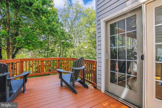 a balcony with wooden floor and outdoor seating