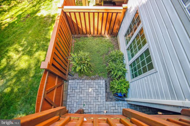 a view of backyard with a deck and a garden
