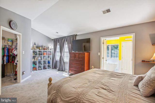 a bedroom with a bed and a closet