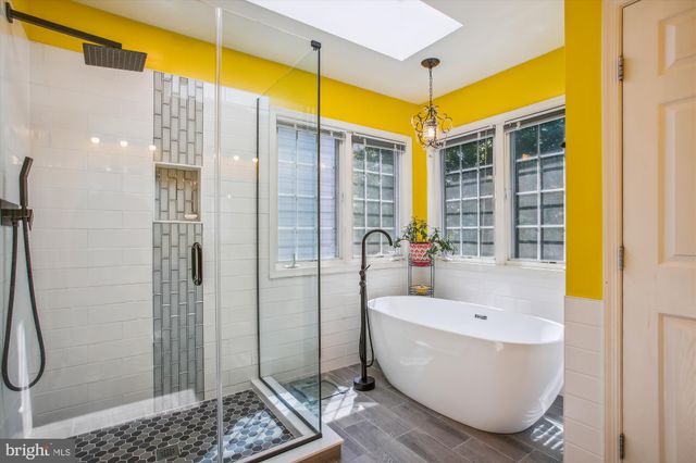 a bathroom with a bathtub and shower