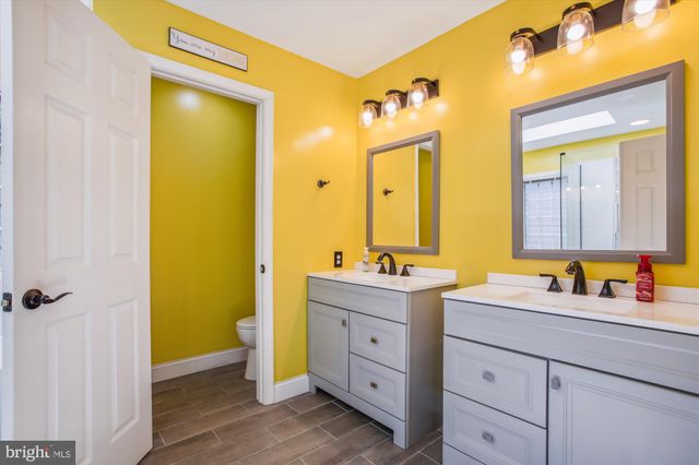 a bathroom with a double vanity sink and a mirror
