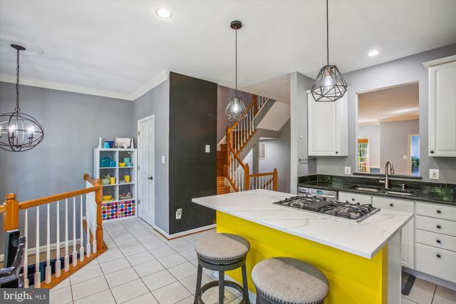 a kitchen that has a table chairs and refrigerator