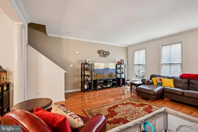 a view of a dining room with furniture a chandelier and wooden floor