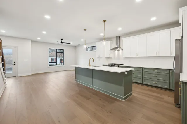 a kitchen with stainless steel appliances kitchen island wooden cabinets and granite counter tops