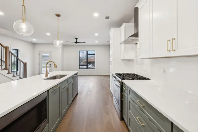 a kitchen with kitchen island a sink stove and wooden floor