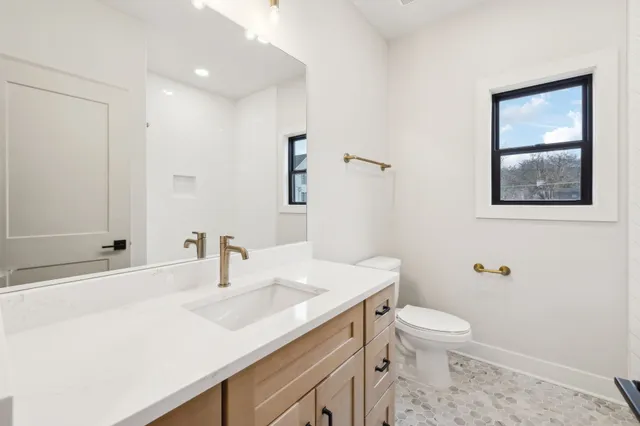a bathroom with a sink toilet and shower