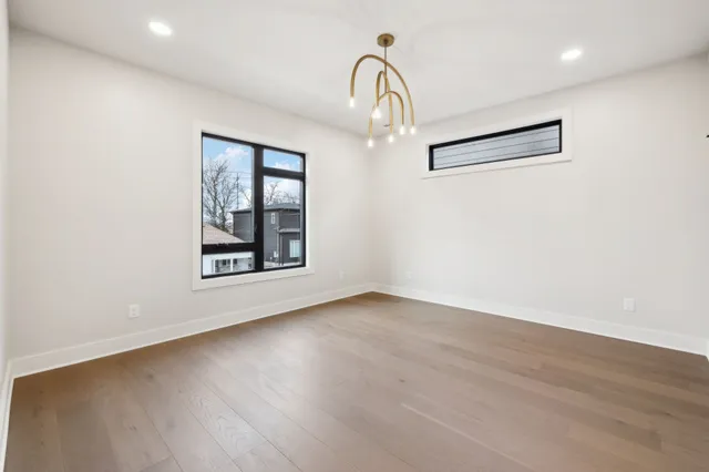 a view of a room with wooden floor and window