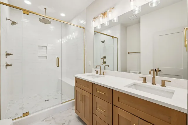 a bathroom with a shower sink and mirror