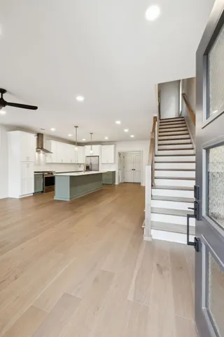 a view of kitchen with sink and refrigerator