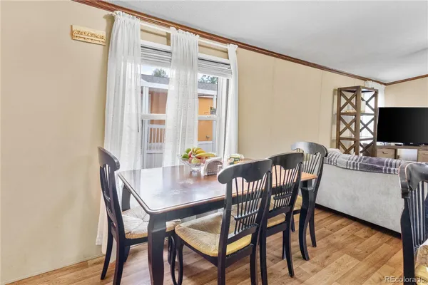 a view of a dining room with furniture and a flat screen tv