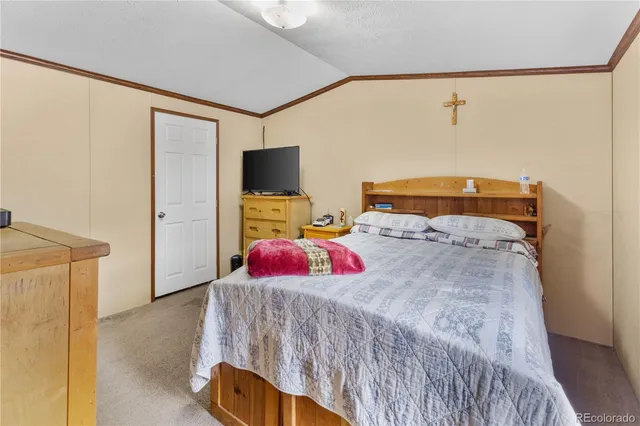 a bedroom with a bed and a flat tv screen