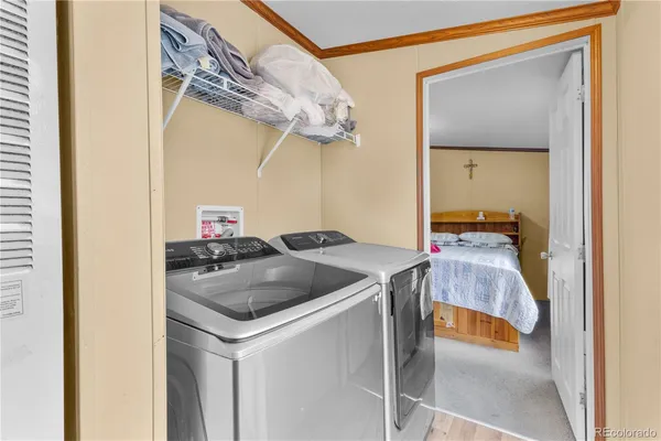 a utility room with a sink and mirror