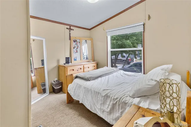a bedroom with a bed and a large window