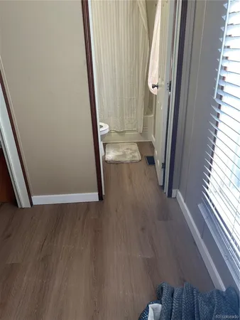 a view of a hallway view with wooden floor and staircase