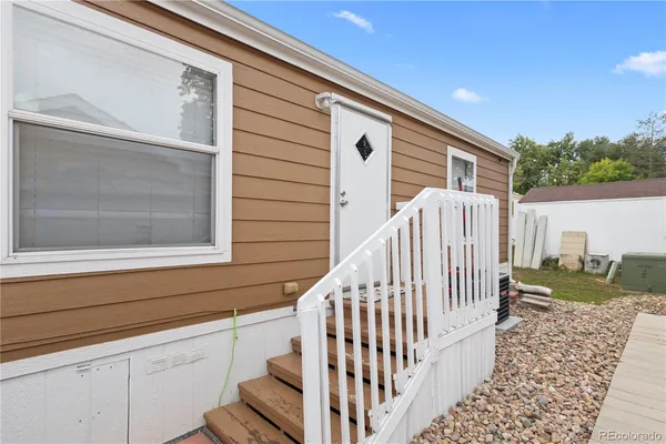 a view of a porch with wooden floor and fence