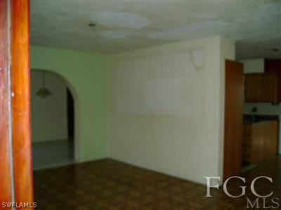 1437 Mandel Road Fort Myers, FL 33919 - Photo 2 of 8 an empty room with wooden floor