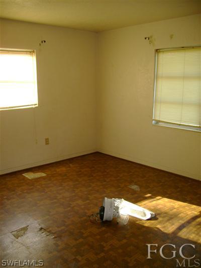 1437 Mandel Road Fort Myers, FL 33919 - Photo 4 of 8 a view of empty room with wooden floor