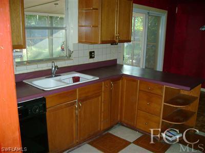 1437 Mandel Road Fort Myers, FL 33919 - Photo 5 of 8 a kitchen with a sink and a mirror