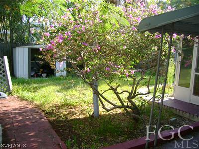 1437 Mandel Road Fort Myers, FL 33919 - Photo 8 of 8 a backyard of a house with lots of green space