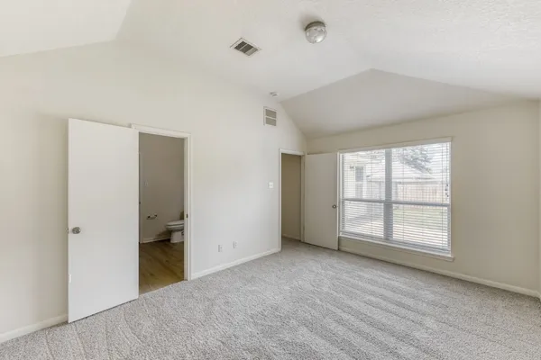 an empty room with windows and closet