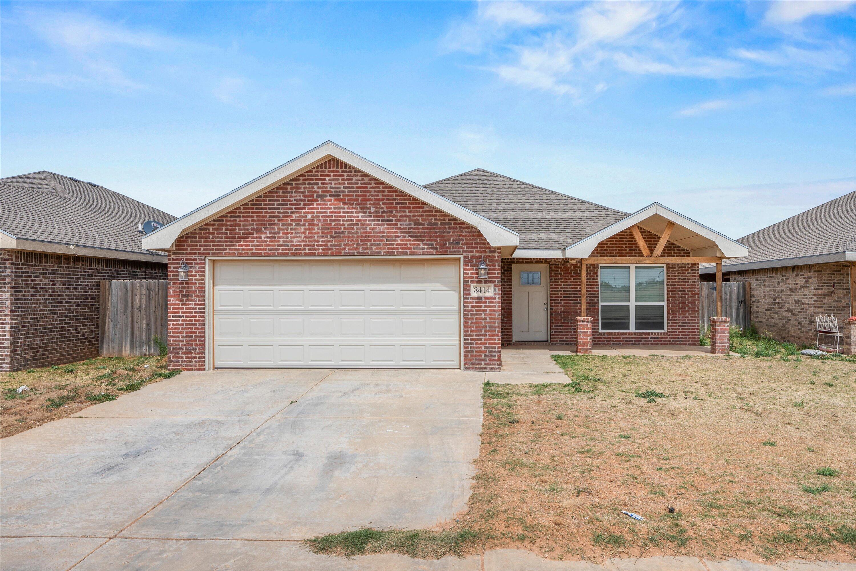 a view of a house with a yard and garage