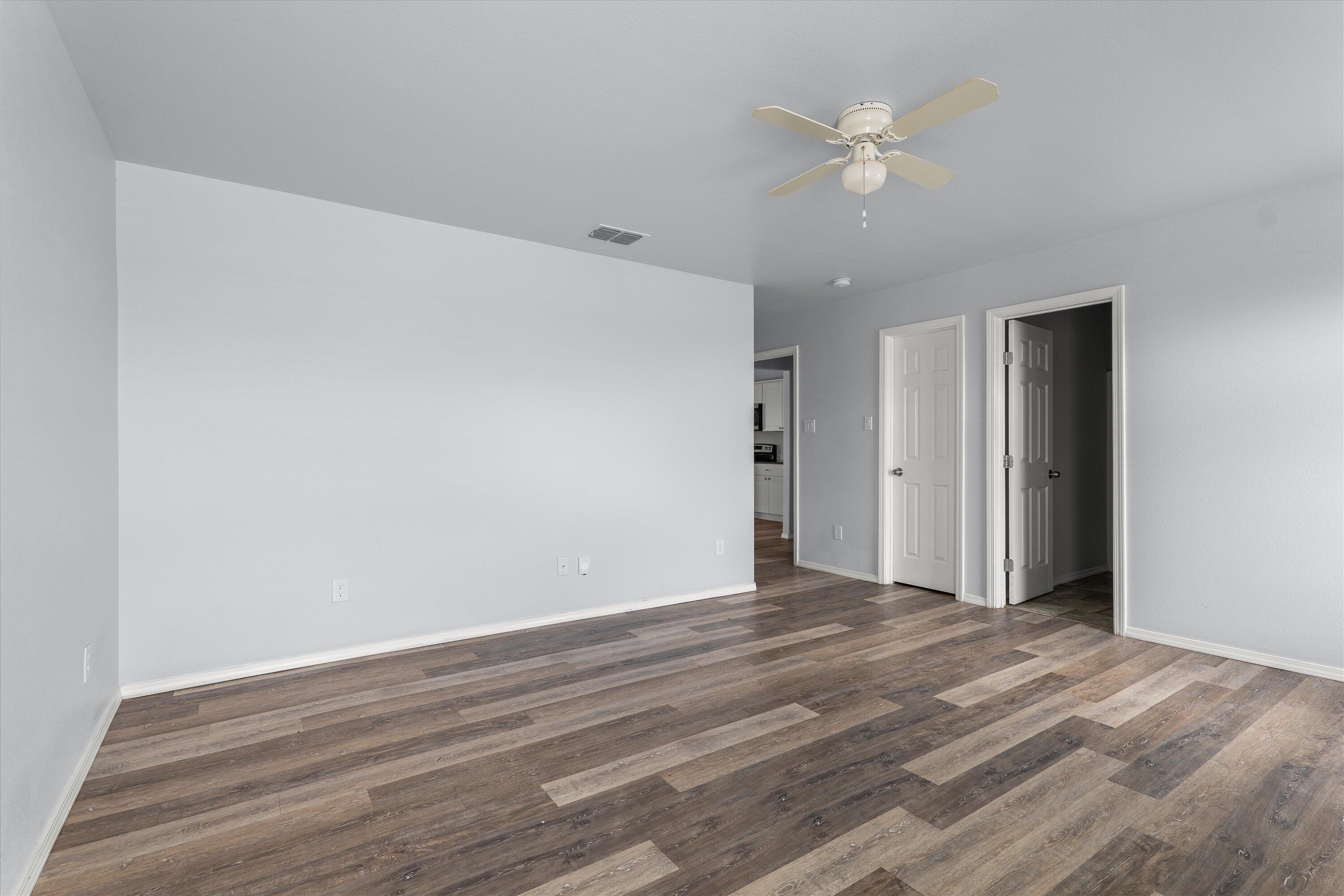 8414 11th Street Lubbock, TX 79416 - Photo 15 of 26 a view of an empty room with a ceiling fan