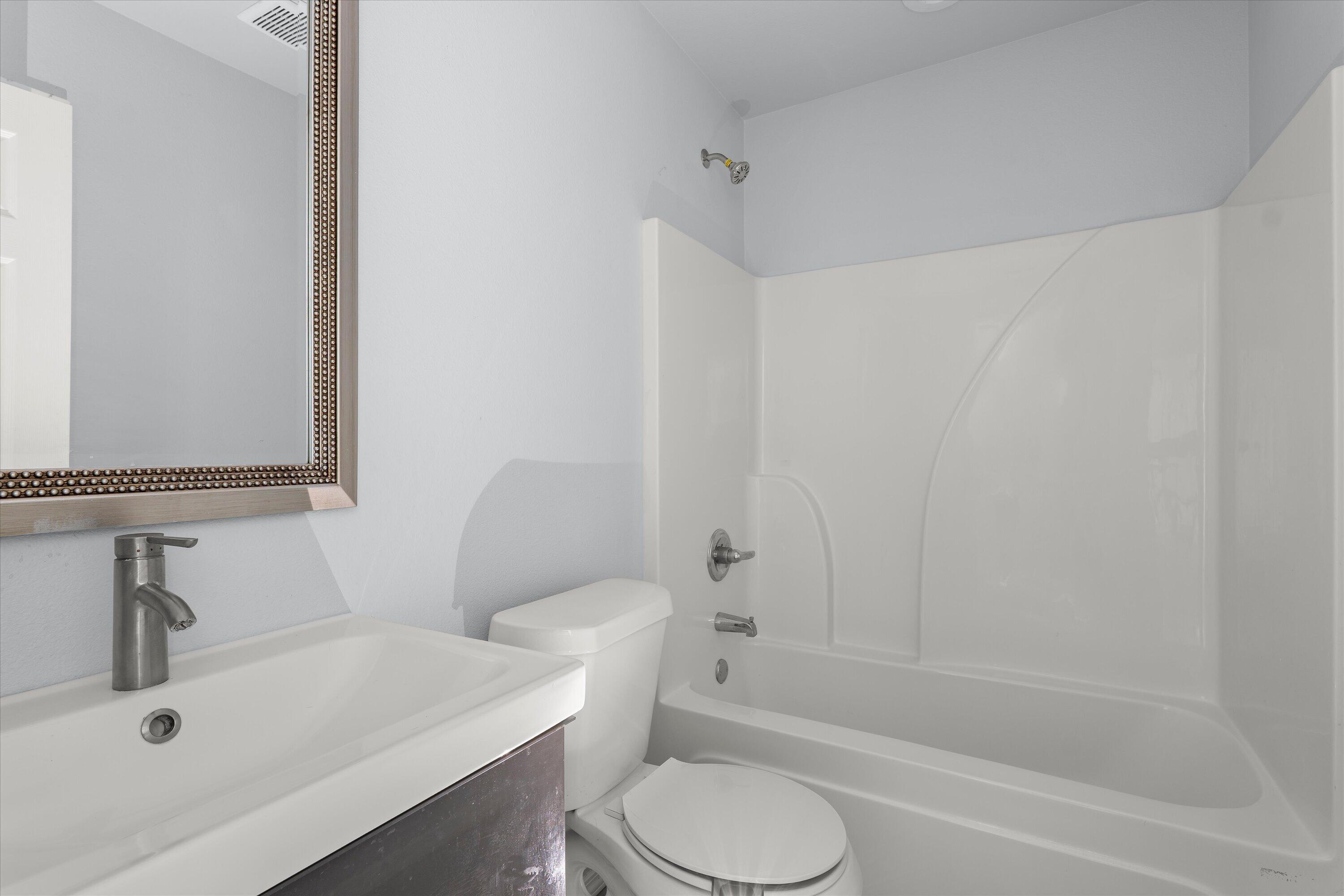 8414 11th Street Lubbock, TX 79416 - Photo 20 of 26 a bathroom with a sink toilet and shower