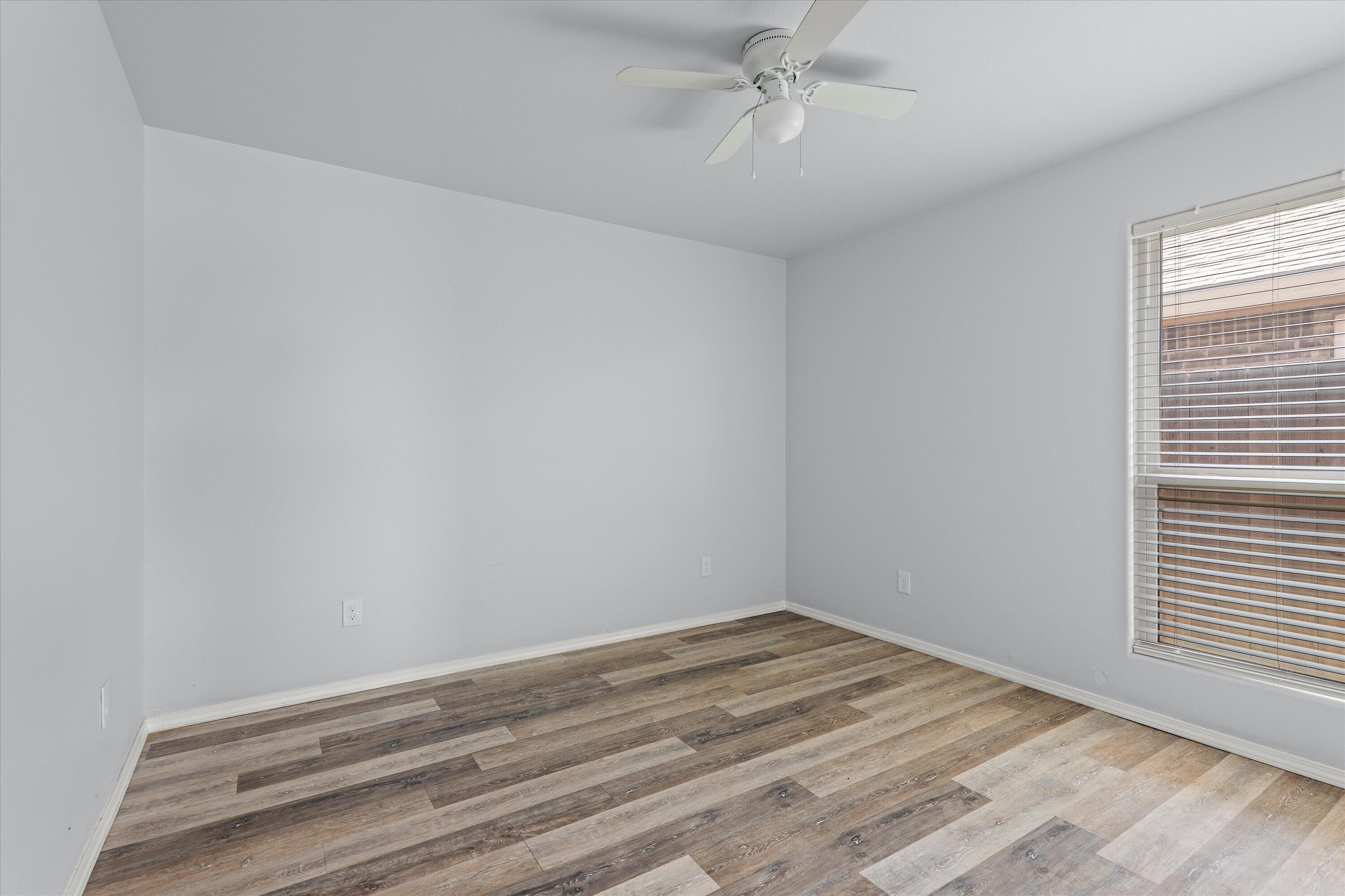 8414 11th Street Lubbock, TX 79416 - Photo 21 of 26 a view of a room that has a bed and a window
