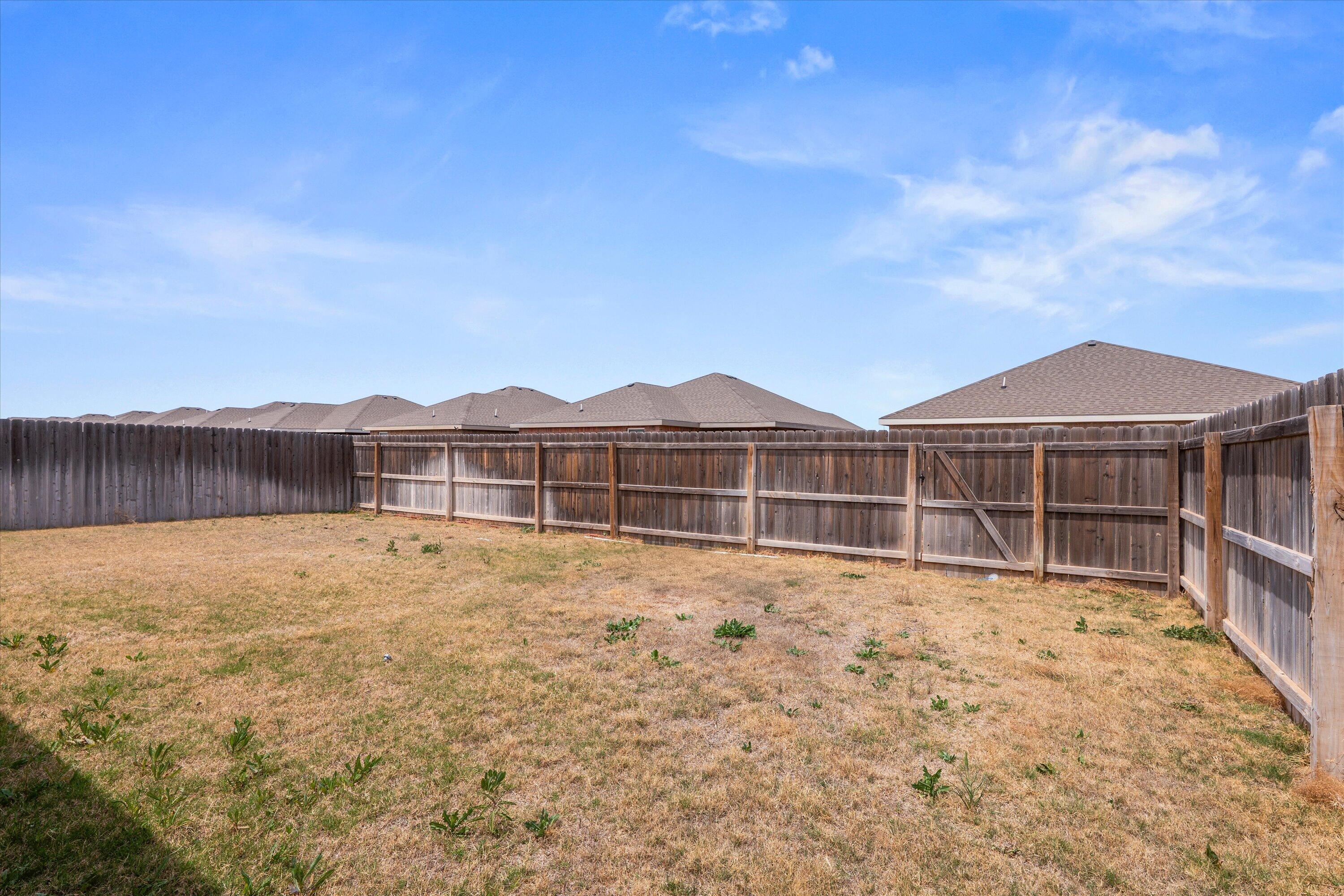 8414 11th Street Lubbock, TX 79416 - Photo 23 of 26 a view of an house with wooden fence