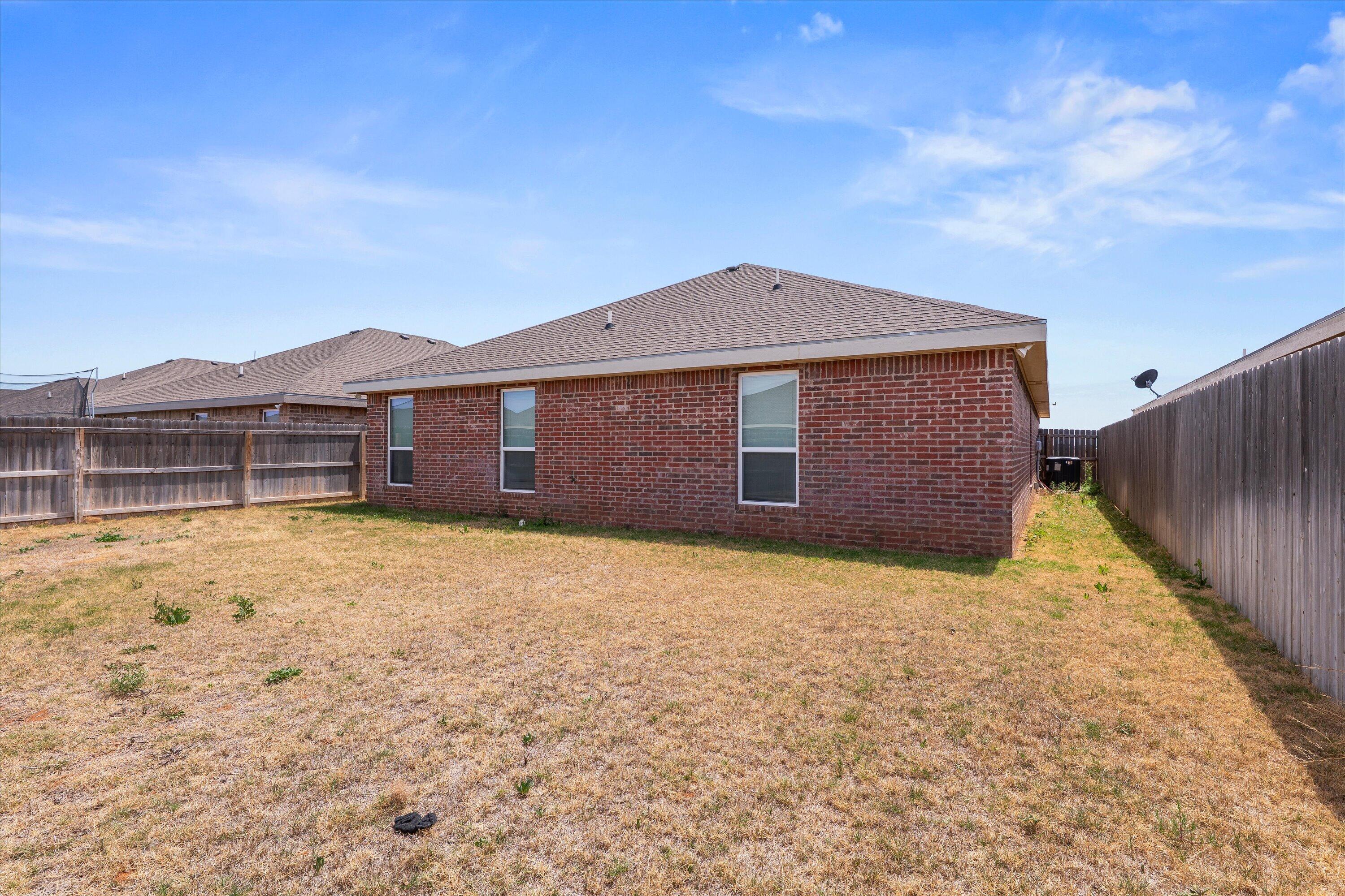 8414 11th Street Lubbock, TX 79416 - Photo 25 of 26 a front view of a house with a yard