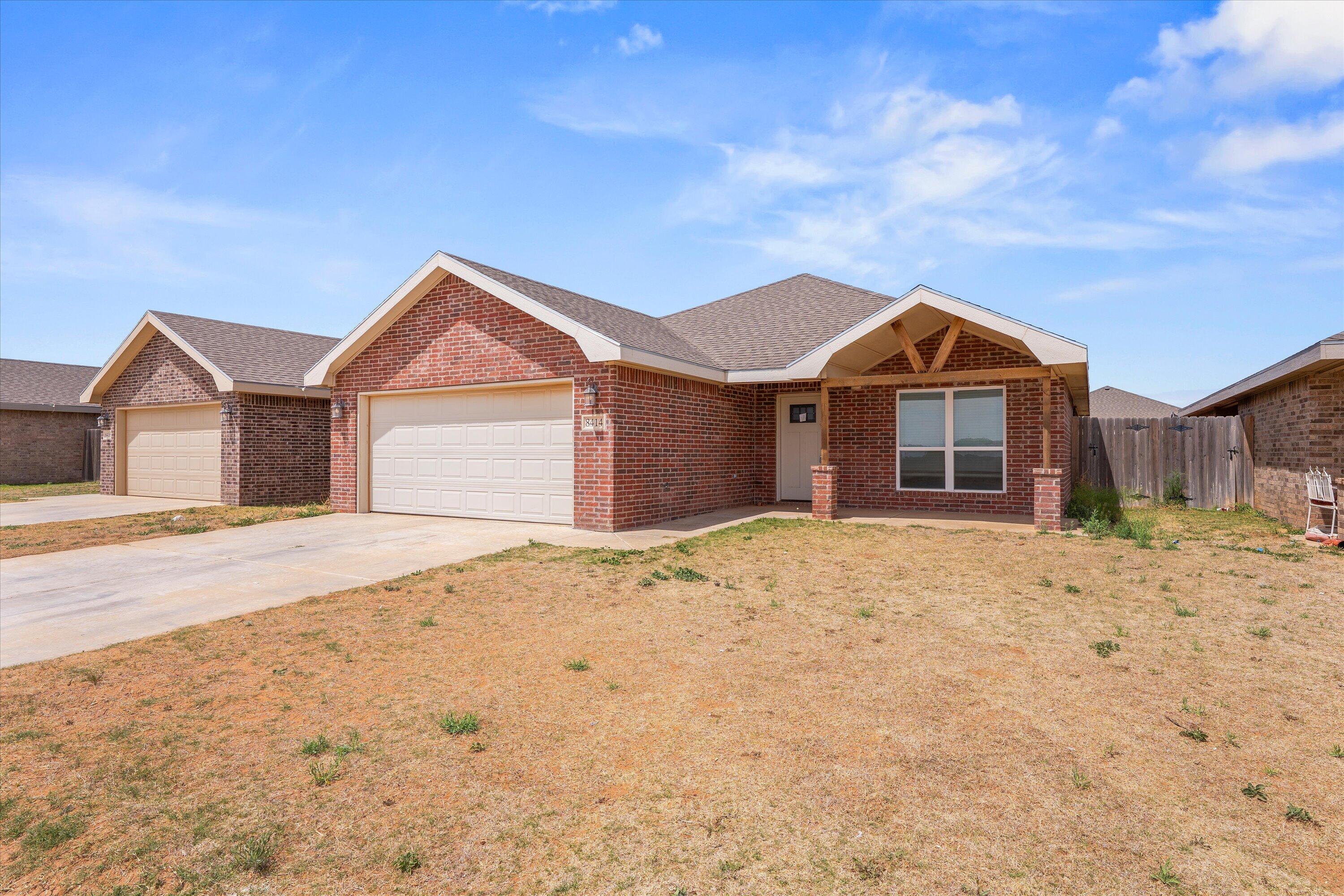 8414 11th Street Lubbock, TX 79416 - Photo 4 of 26 a front view of a house with a yard