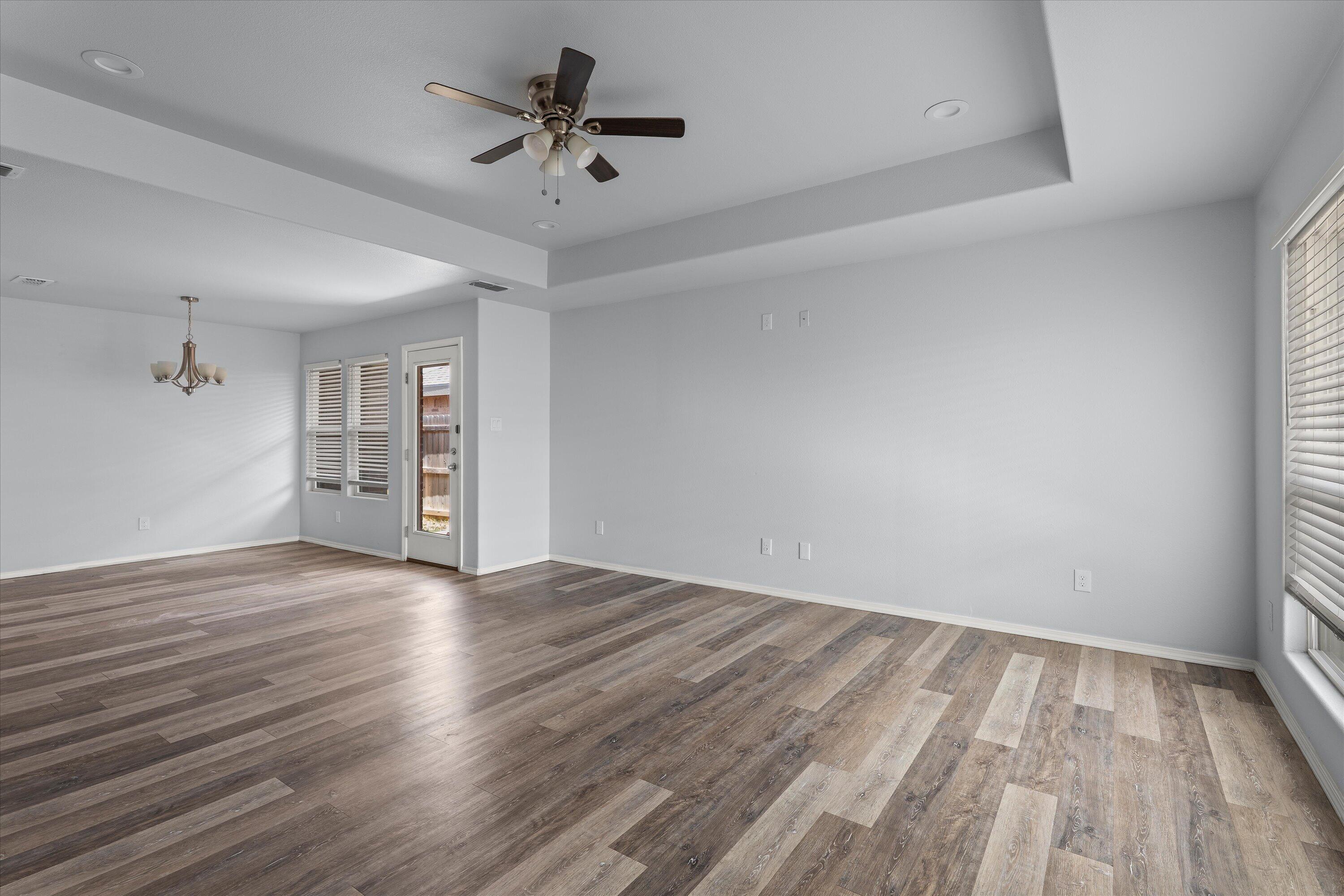 8414 11th Street Lubbock, TX 79416 - Photo 6 of 26 wooden floor in an empty room with a window
