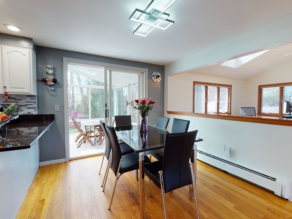30 Kingston Road Waltham, MA 02451 - Photo 12 of 41 a view of a dining room with furniture a chandelier and wooden floor