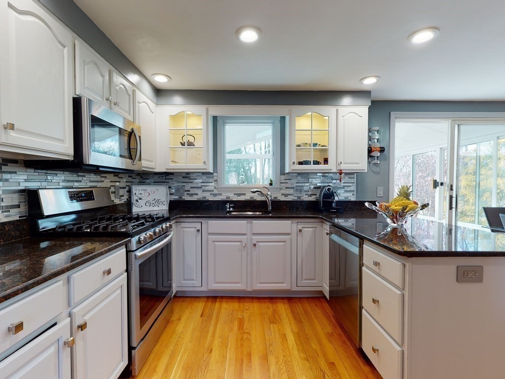 30 Kingston Road Waltham, MA 02451 - Photo 15 of 41 a kitchen with stainless steel appliances granite countertop a stove a sink and a granite counter tops