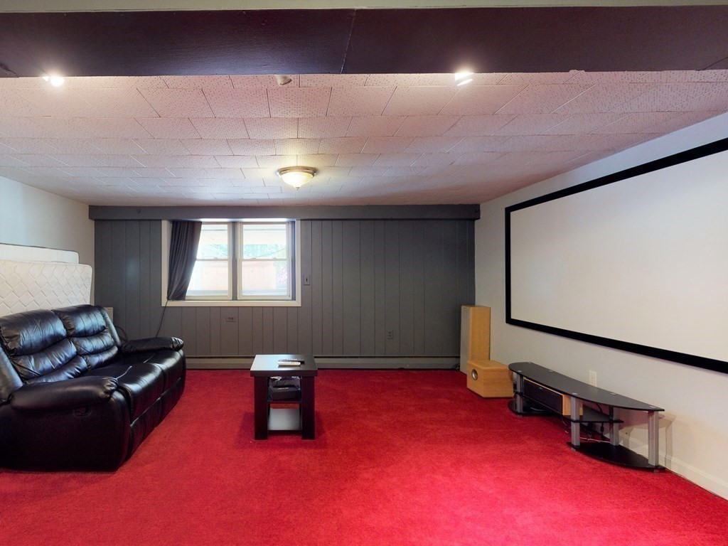 30 Kingston Road Waltham, MA 02451 - Photo 23 of 41 a living room with furniture and a flat screen tv