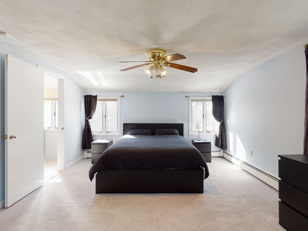 30 Kingston Road Waltham, MA 02451 - Photo 25 of 41 a bedroom with a bed and a chandelier