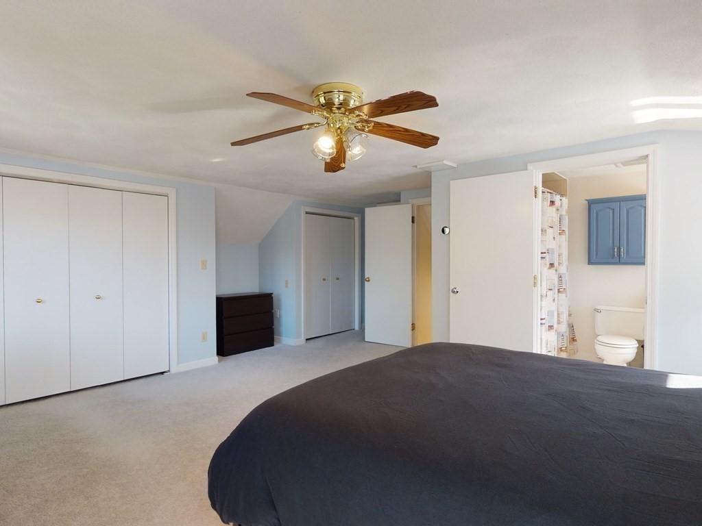 30 Kingston Road Waltham, MA 02451 - Photo 26 of 41 a bedroom with a bed and a chandelier